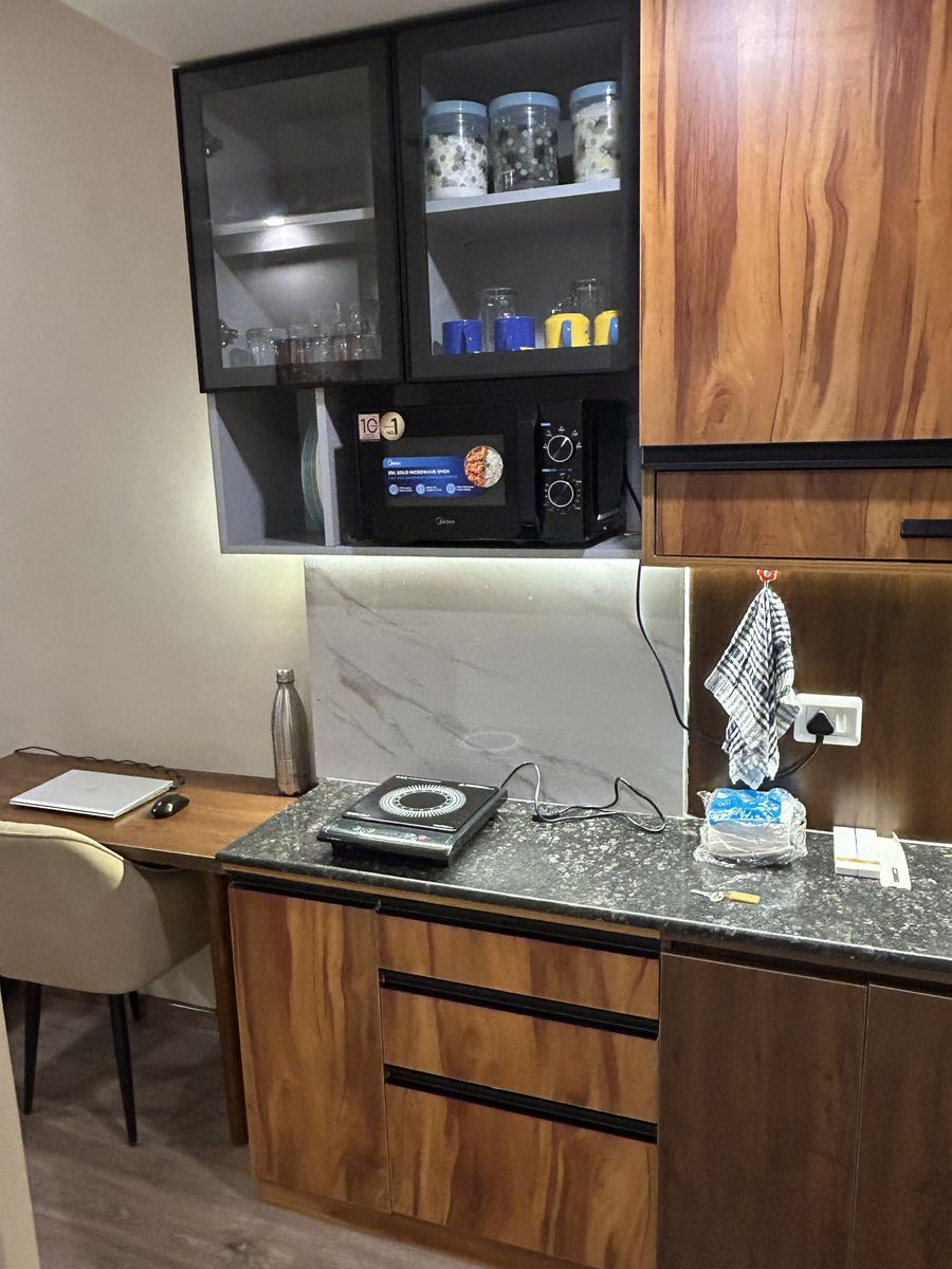 Compact kitchenette induction cooking area in noida stay