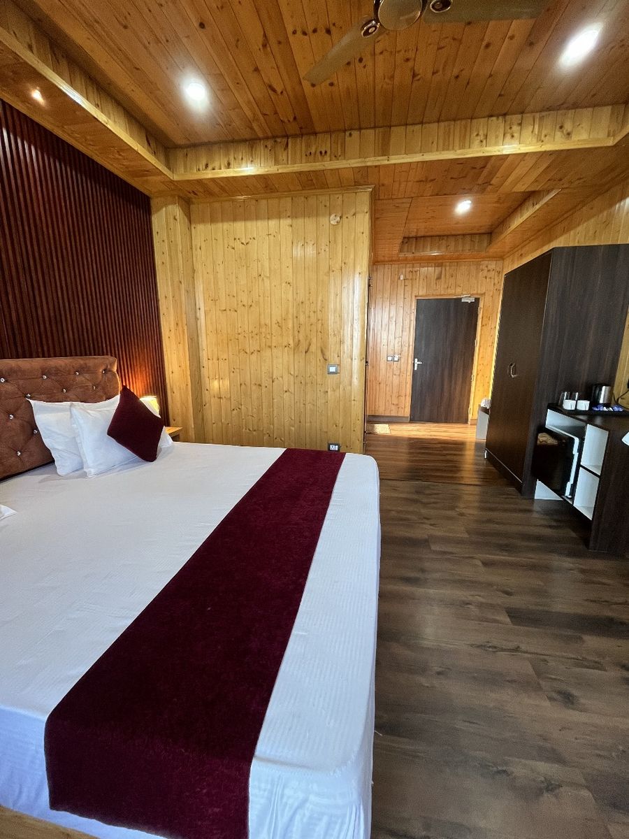 Comfortable double bed with wooden interior finishes in Kasauli
