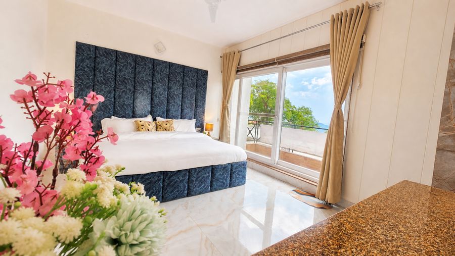 Bright master bedroom large window homestay in mussoorie