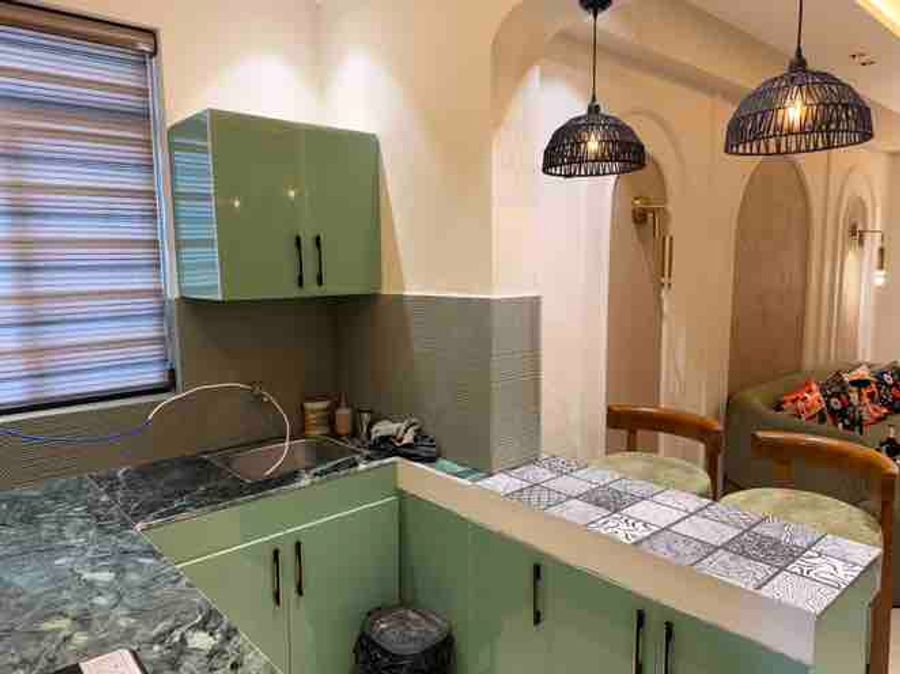 Open kitchen counter and hanging lights at luxury loft stay