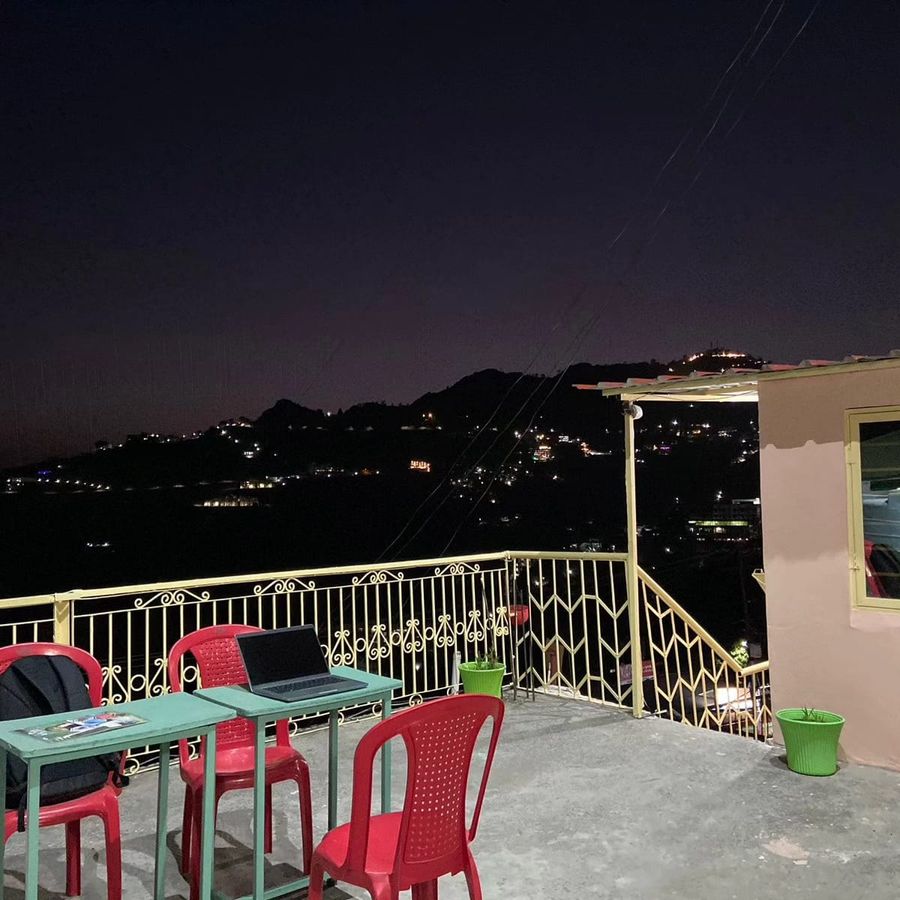Night balcony terrace city view at sunny home stay