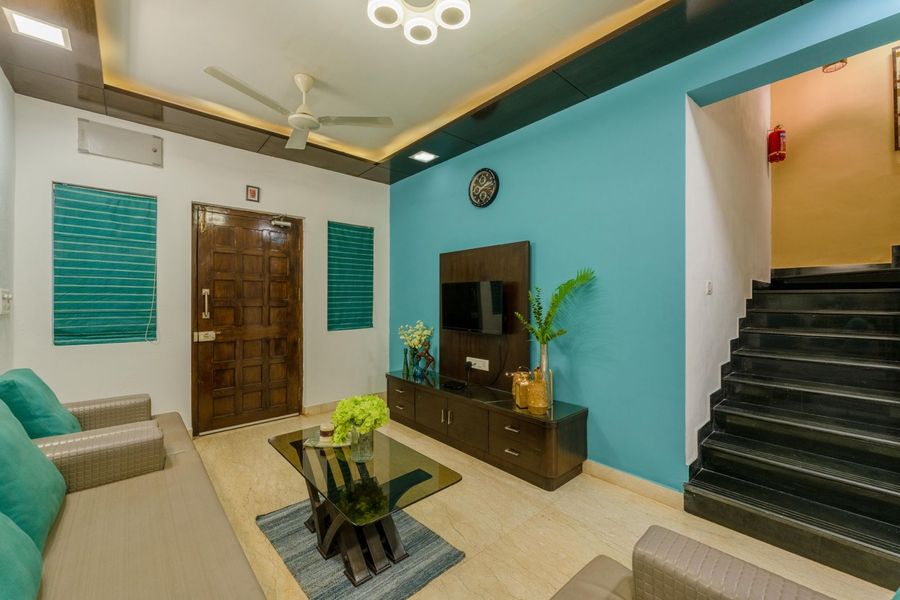 Living hall with stairs and tv unit oasis villa assagao