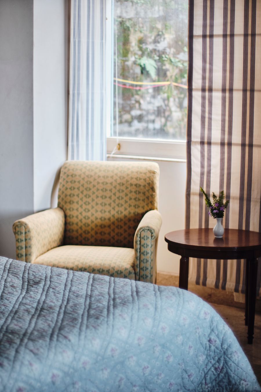 Comfortable reading armchair with small side table in Kasauli