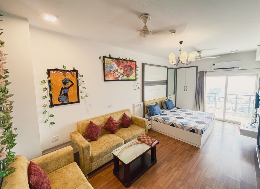 Living area sofa seating with double bed at richas home noida