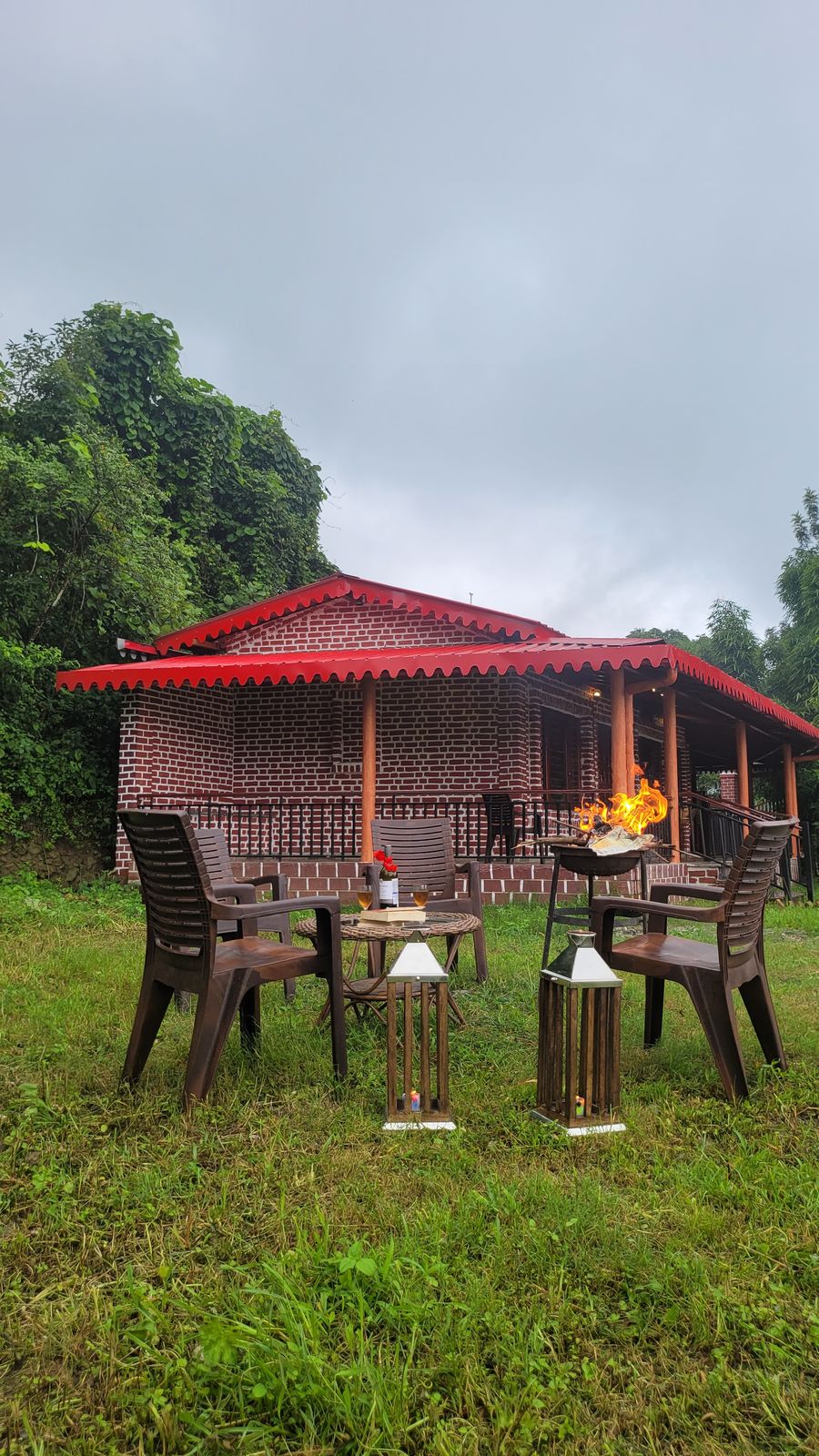 Garden patio seating setup with evening campfire grill in Bhimtal