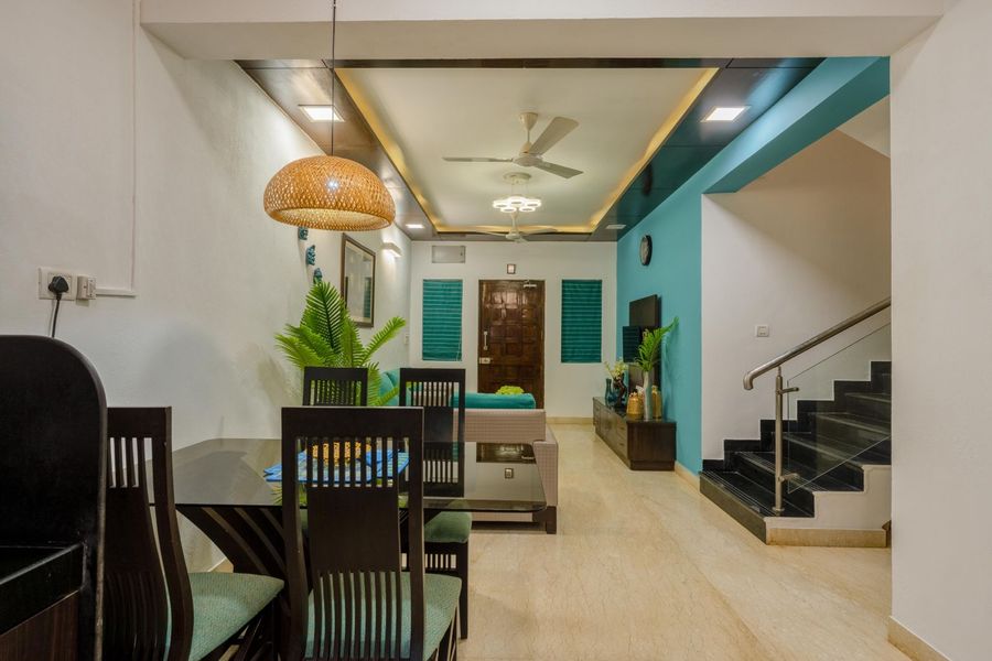 Indoor dining area with staircase oasis 3 bhk villa goa