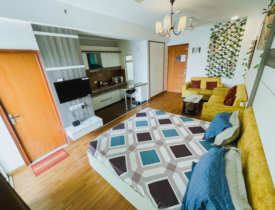 Studio apartment bedroom and sofa lounge at richas home noida