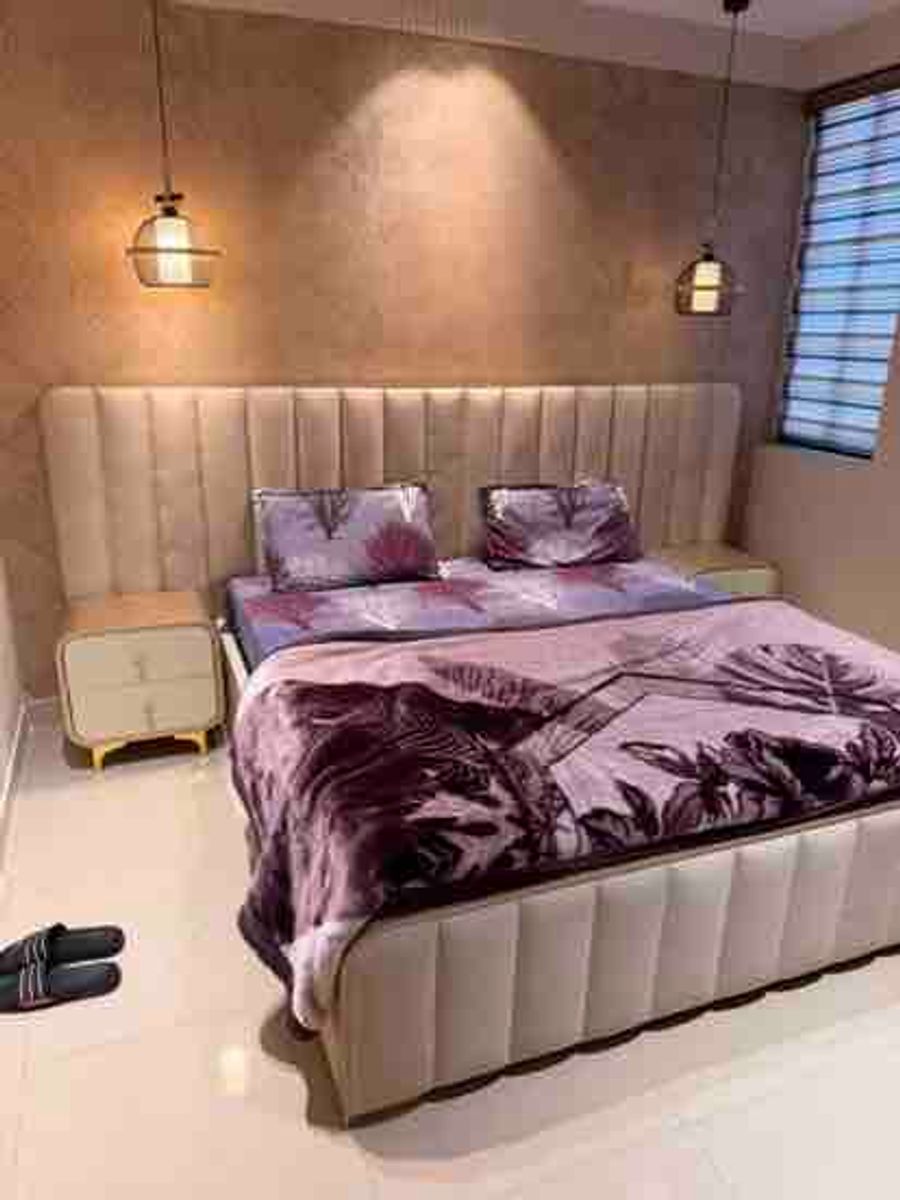 Spacious bedroom with double bed setup at luxury loft karnal