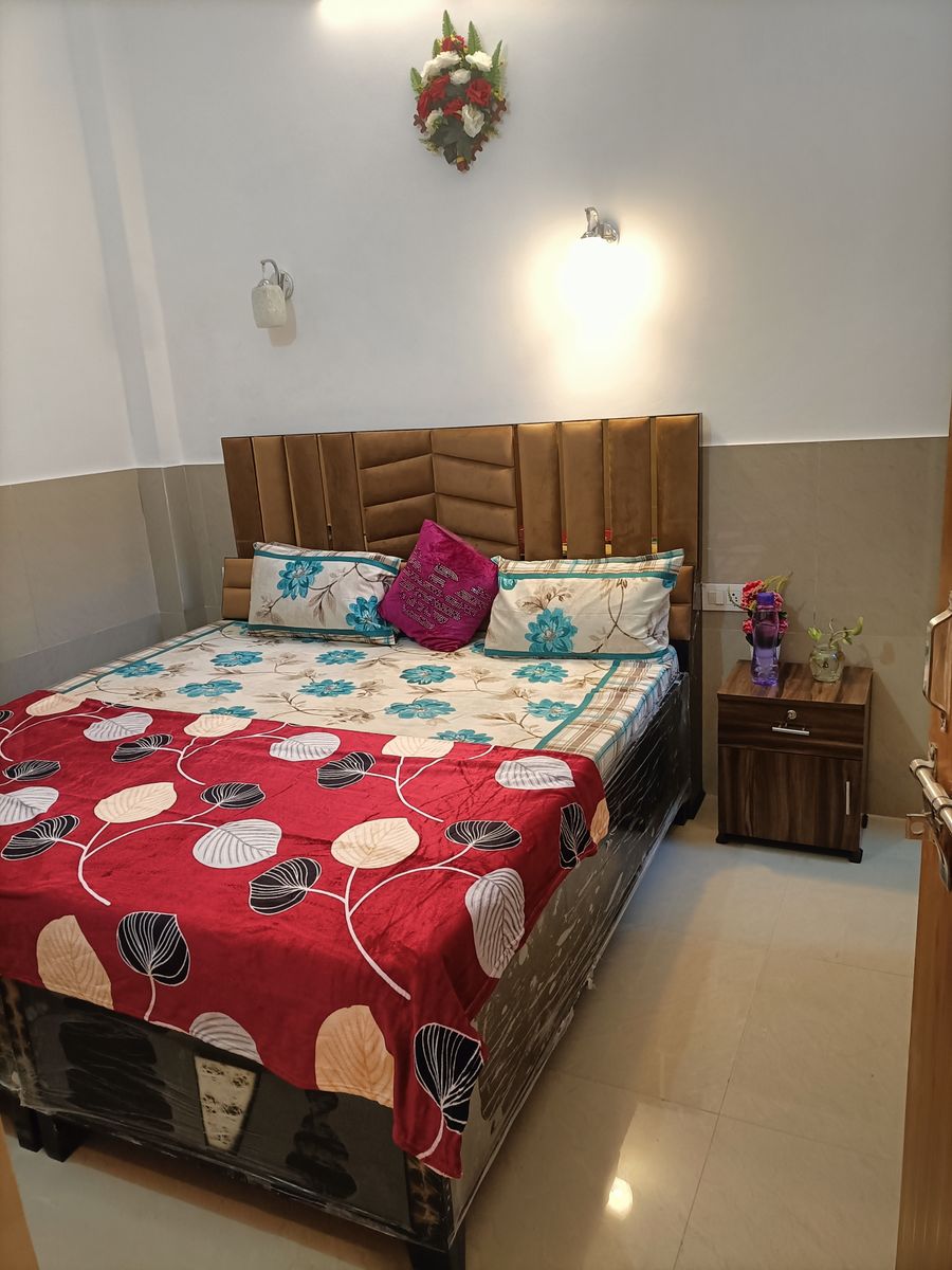 Comfortable double bed with padded headboard and nightstand in Rishikesh