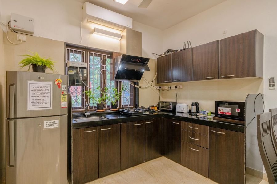 Modern kitchen with wooden cabinets oasis villa assagao