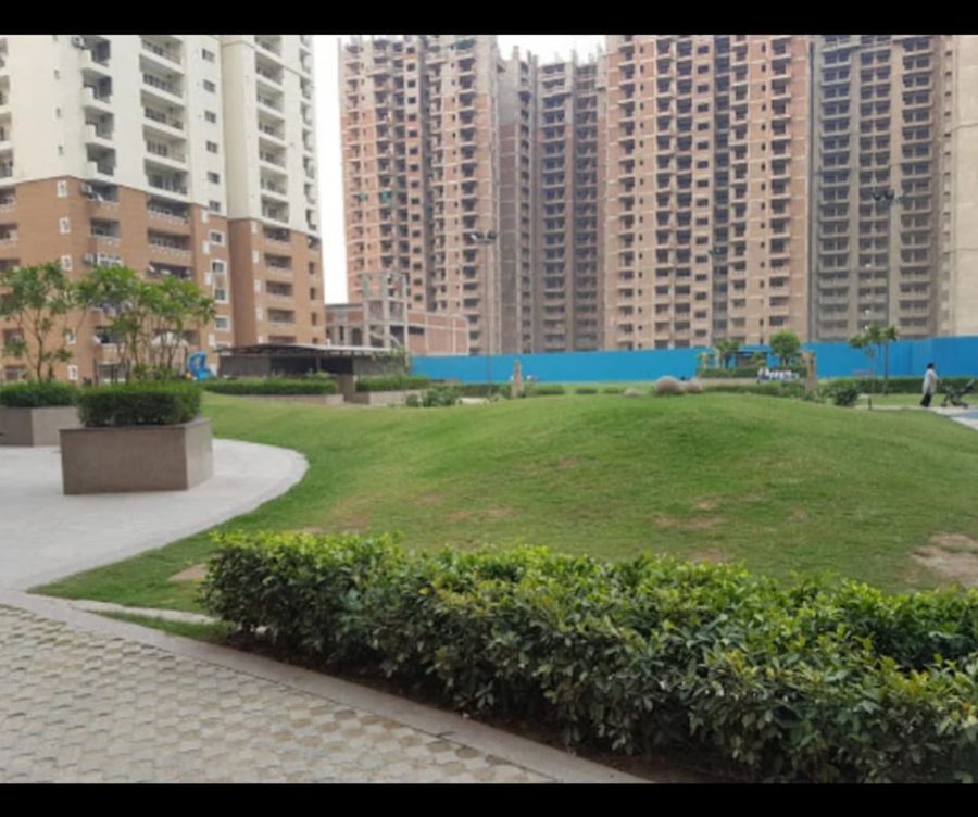 Lush green residential society garden at three knots noida