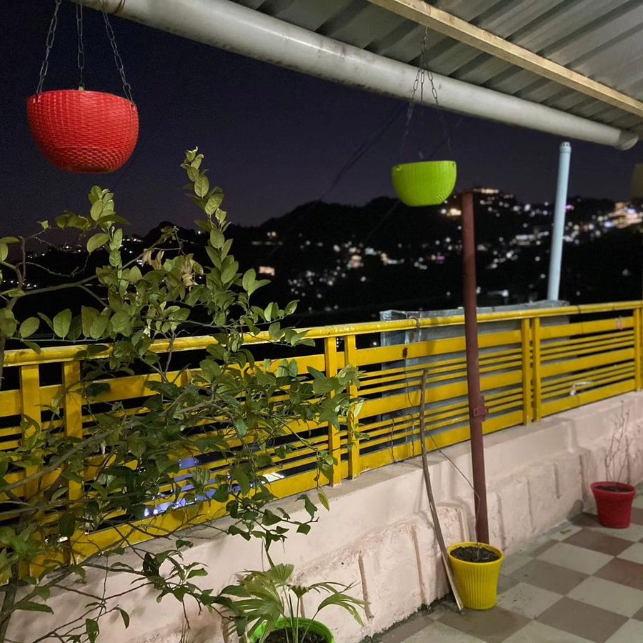 Outdoor terrace garden yellow railing sunny home stay