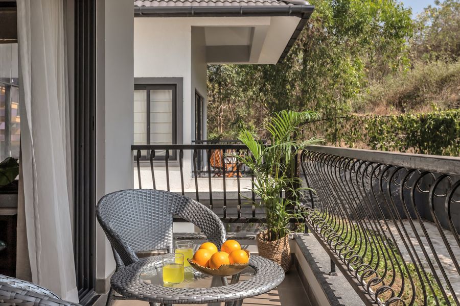 Scenic balcony outdoor seating setup at lavender villa goa