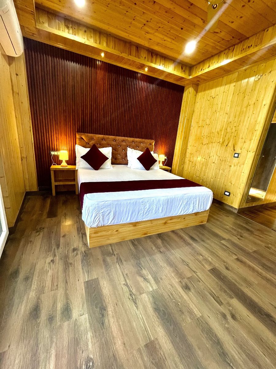 Warm wooden bedroom with double bed and nightstands in Kasauli
