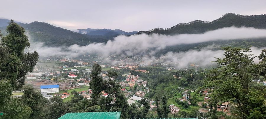 Scenic panoramic valley view with misty clouds in Bhimtal
