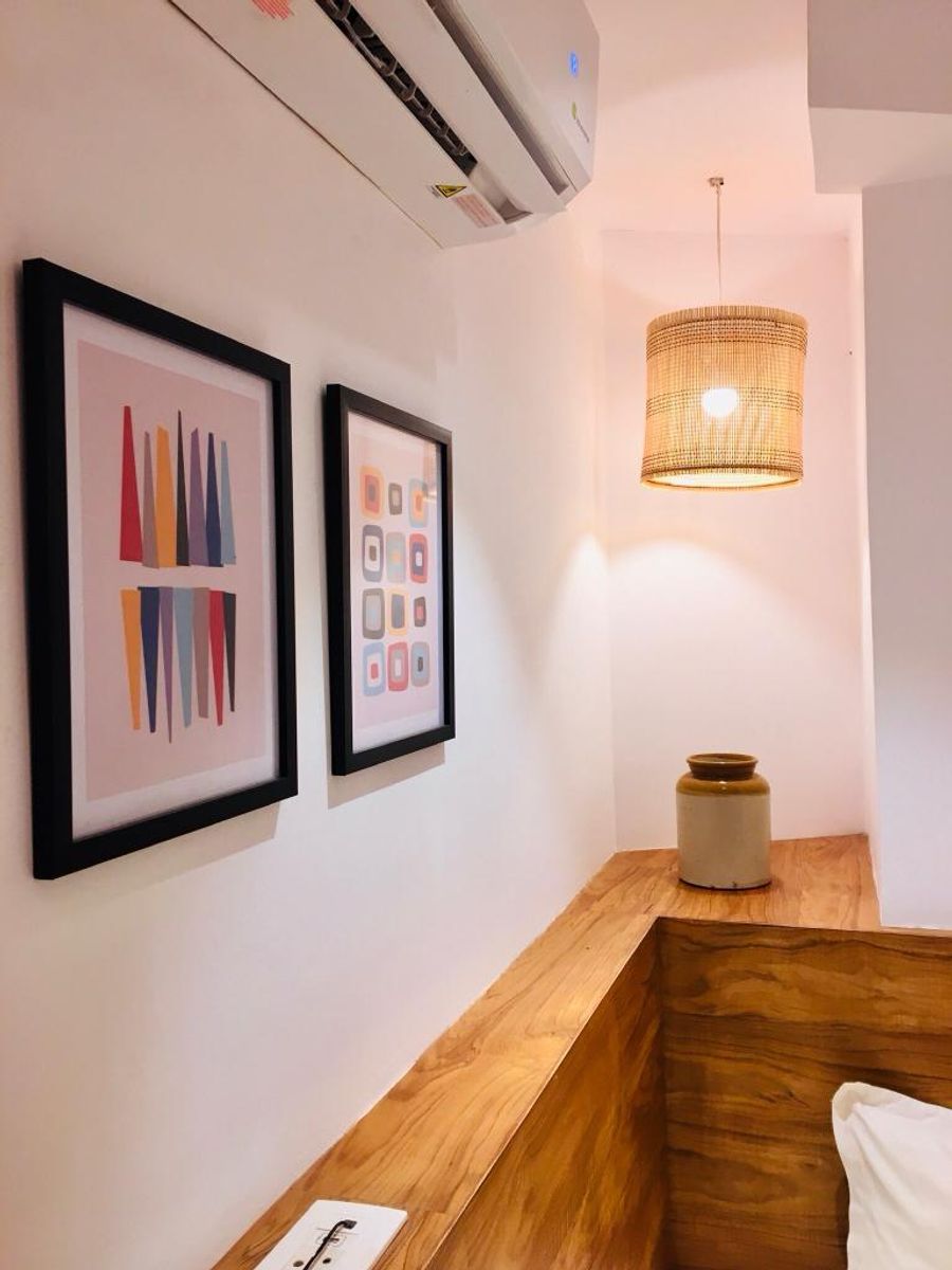 Room corridor with wall art frames at solo pod room 303 goa
