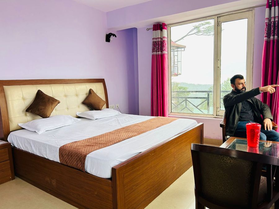 Bright hotel room interior with window view in hotel in shimla