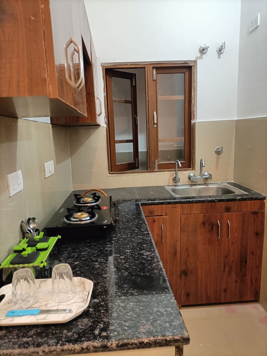 Functional kitchen counter equipped with gas stove and sink in Rishikesh