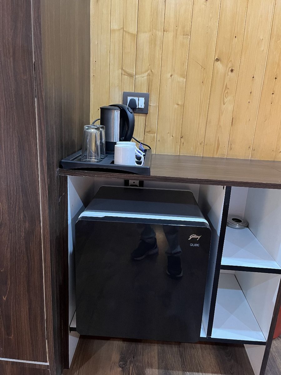 Coffee and tea station with mini-fridge cabinet in Kasauli stay