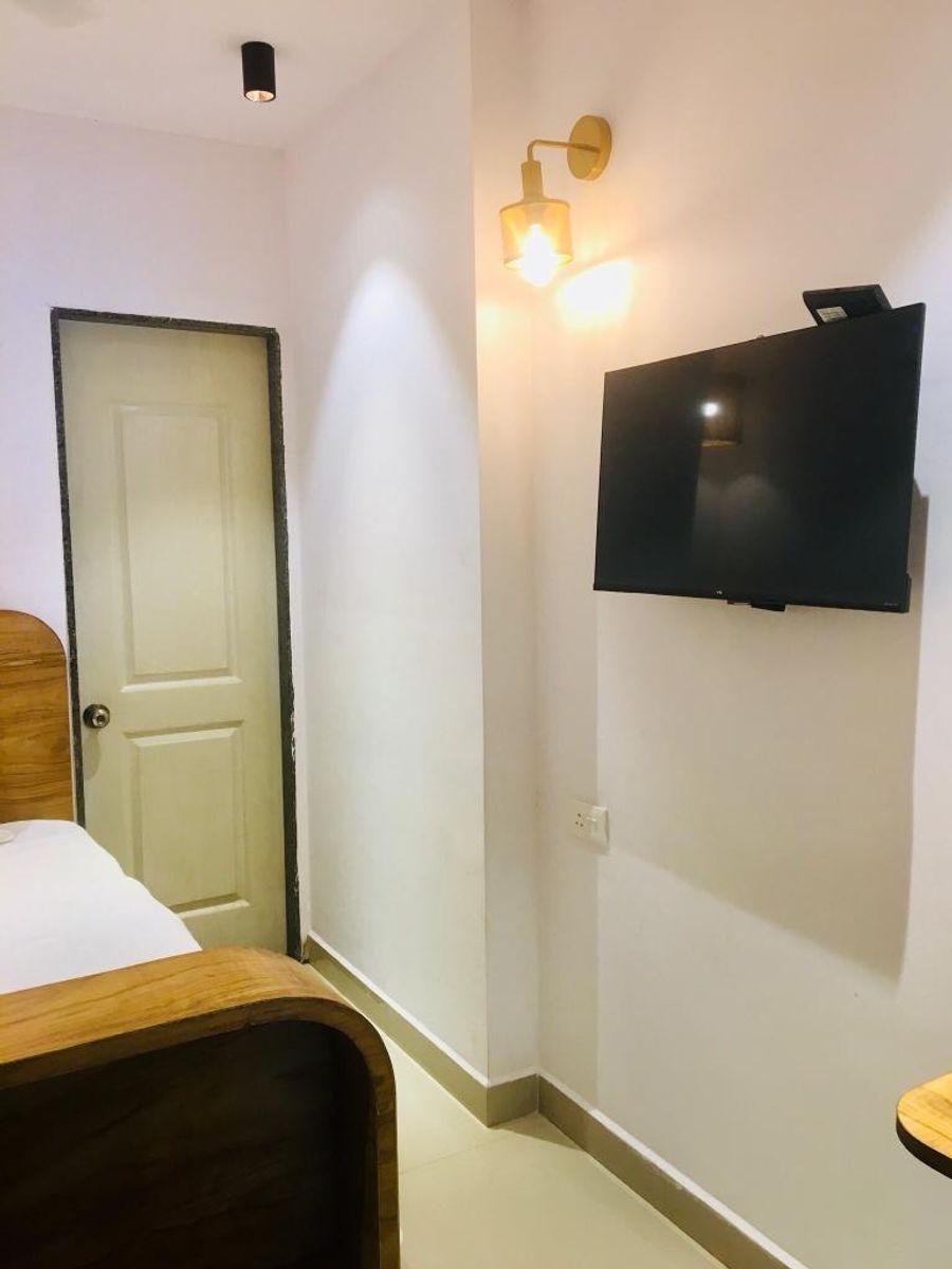 Wall mounted smart tv setup inside solo pod room 303 goa