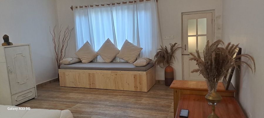 Charming window daybed seating nook with cushions in Bhimtal