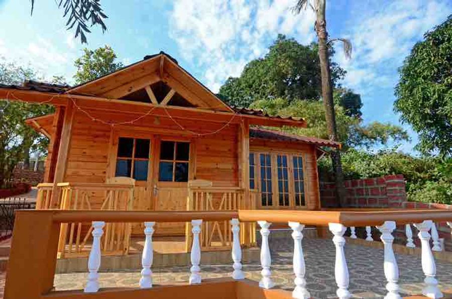 Wooden chalet cottage exterior cozy woods hill resort goa
