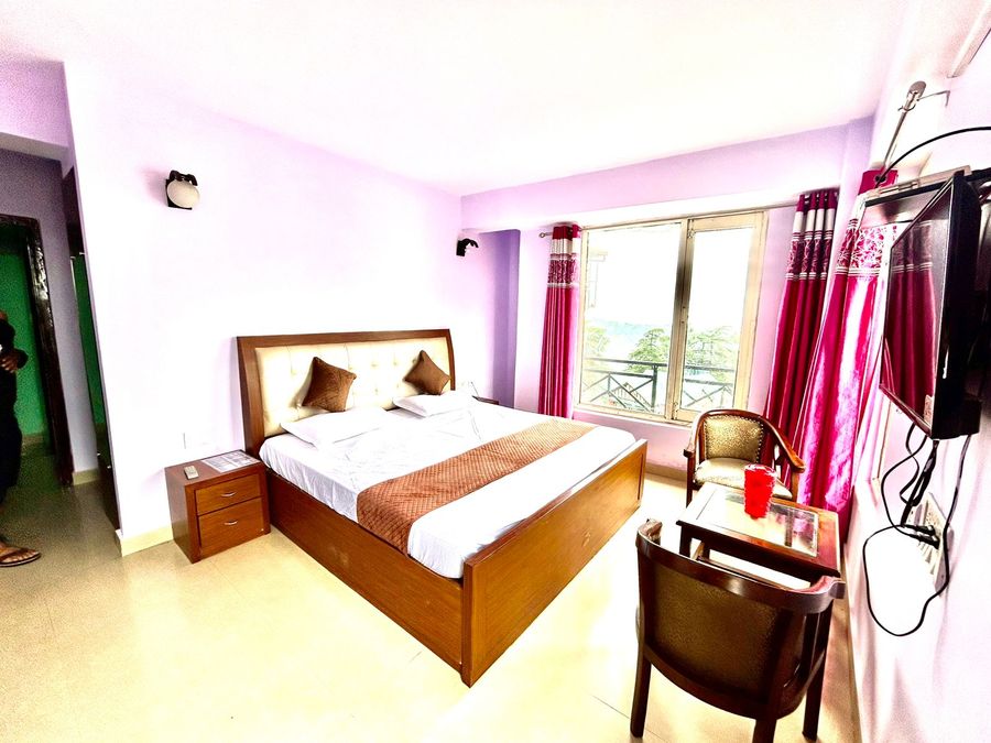 Cozy double bed room setup with pink curtains, hotel in shimla