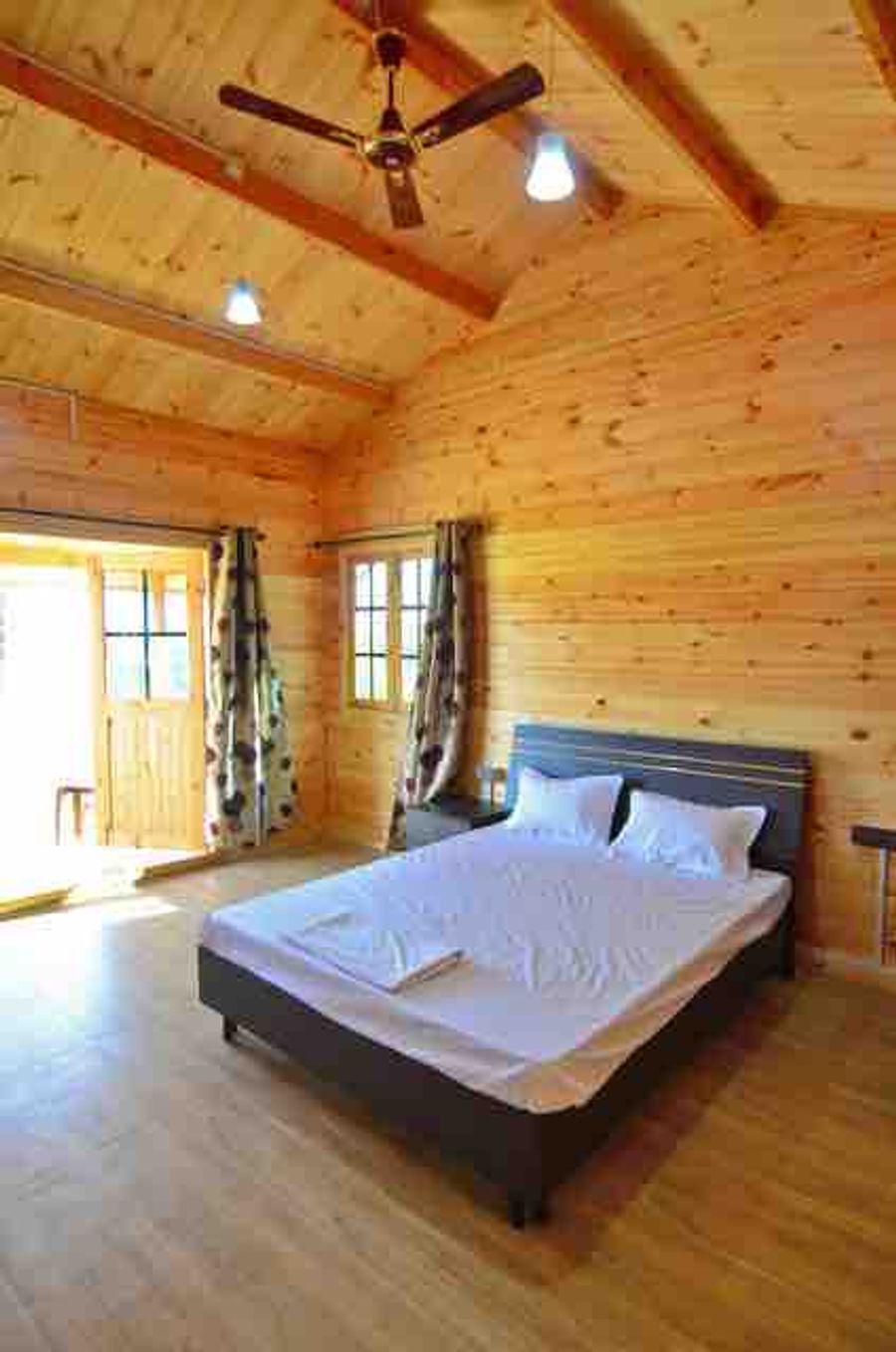 Wooden cottage bedroom interior cozy woods resort goa