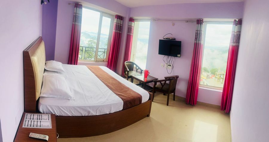 Spacious corner bedroom with valley window at hotel in shimla