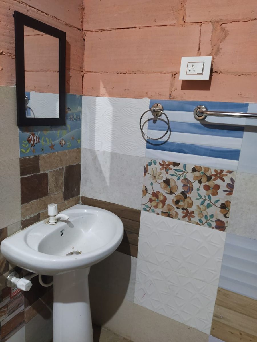 Functional washbasin and tiled vanity setup at campsite in Rishikesh