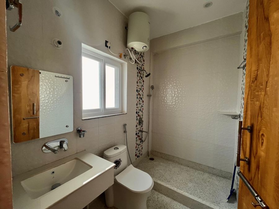 Clean modern bathroom with vanity mirror in Rishikesh