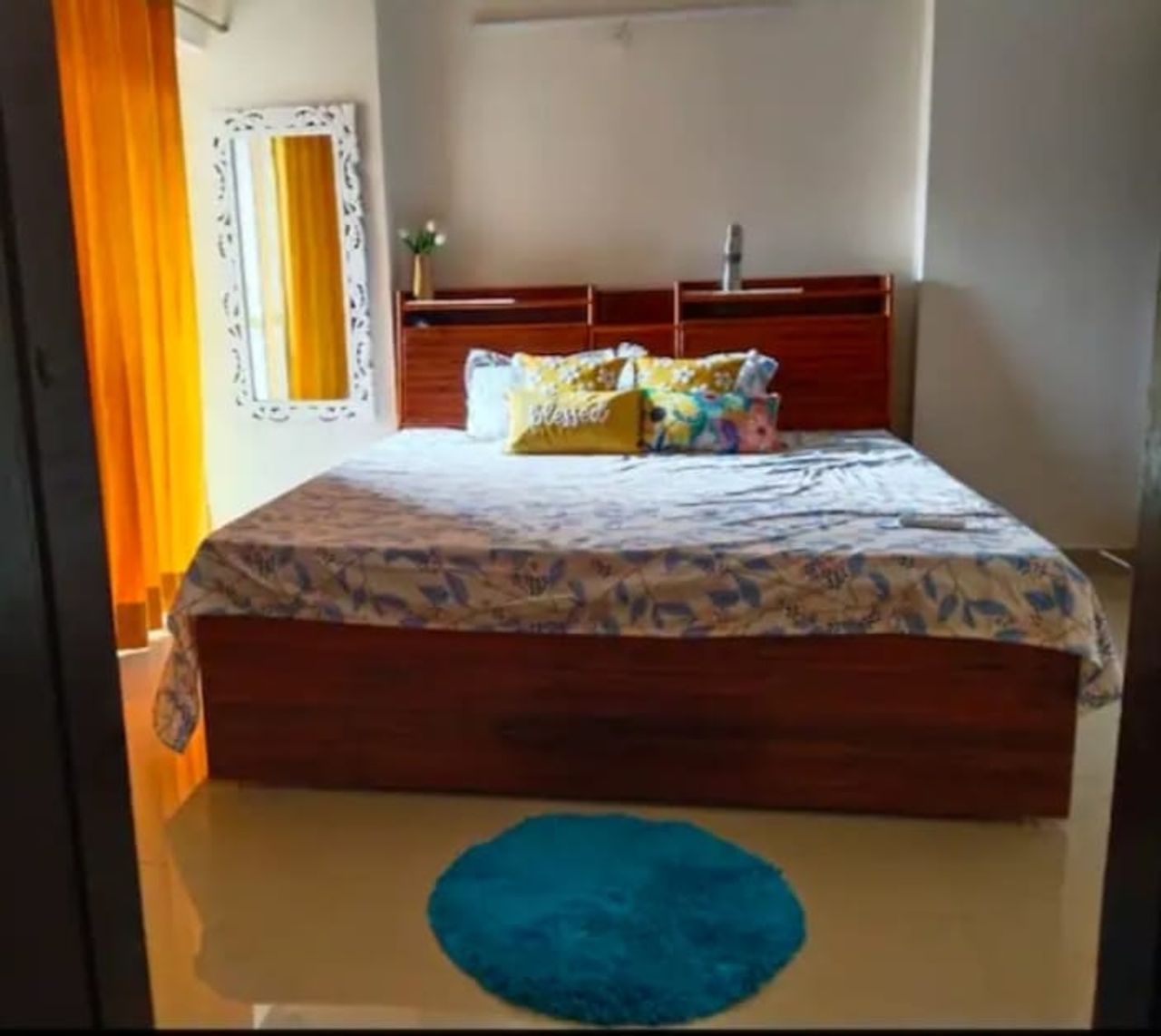 Comfortable wooden double bed room at three knots noida