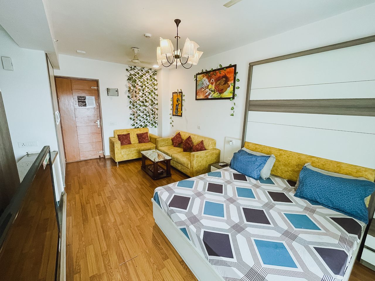 Spacious studio room double bed and couch at richas home noida