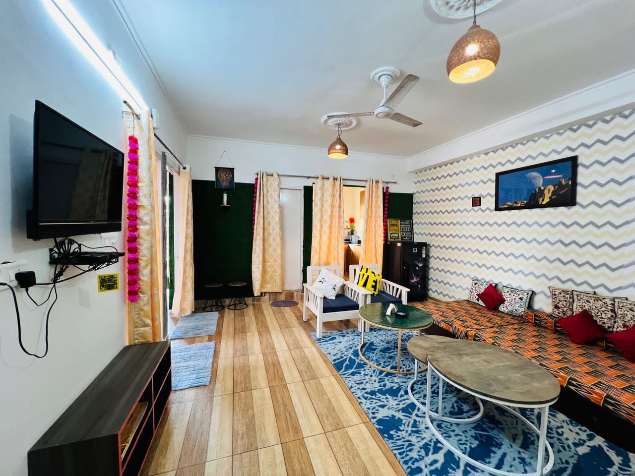 Vibrant living area with floor mattress arrangements, low coffee tables, and bright rugs in Rishikesh
