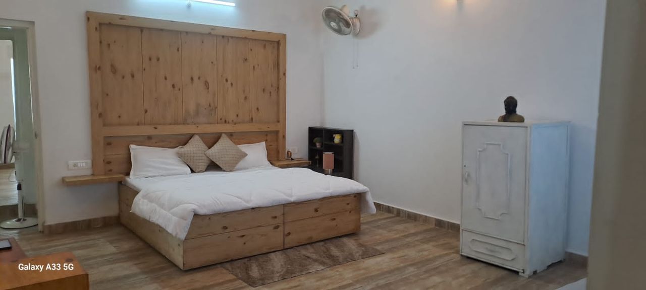 Spacious bedroom suite with wooden flooring in Bhimtal