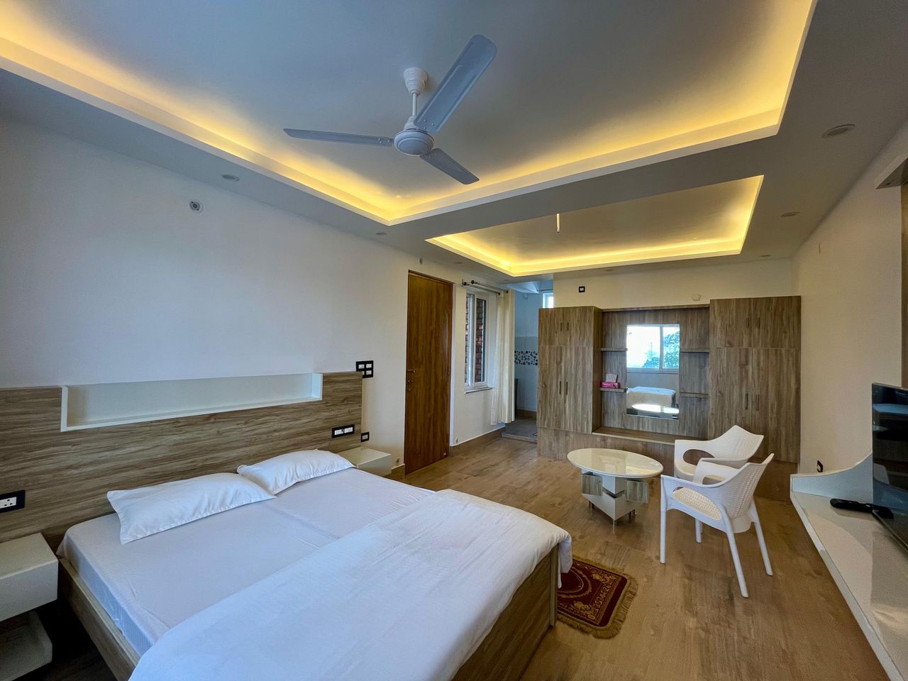 Modern master bedroom with cove lighting in Rishikesh