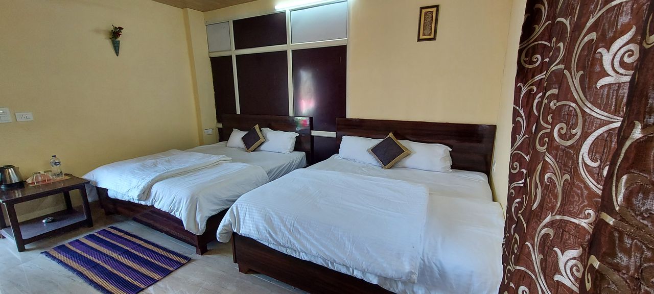 Family bedroom with twin beds at ghai's sunrise homestay